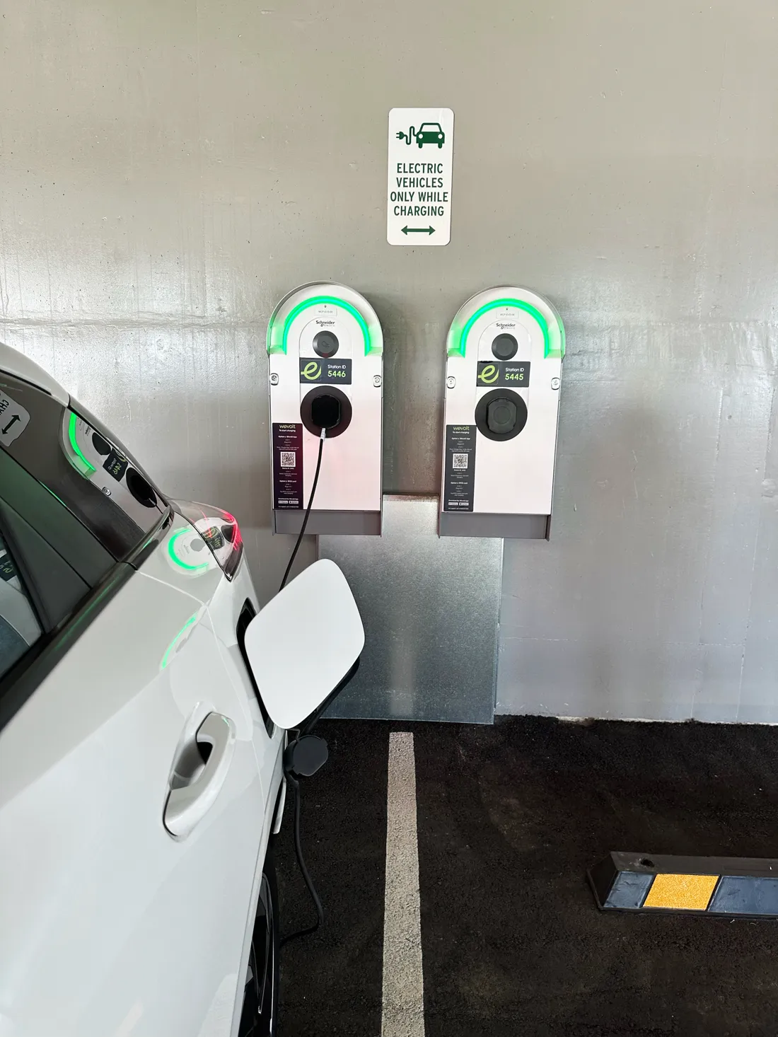 Two Wevolt chargers with green status halos at Morley train station, a car charging
